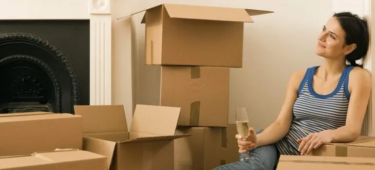 Woman drinking champagne in new home