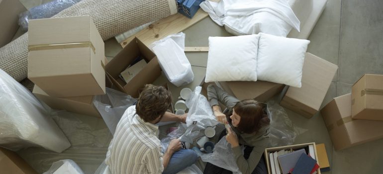 Couple surrounded by boxes packing
