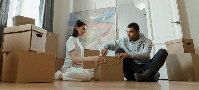couple packing a kitchen cardboard box