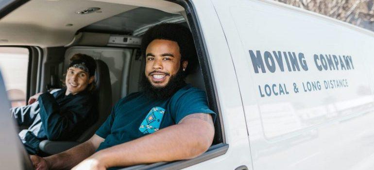 two movers inside a moving van