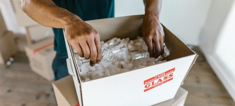 one of the long distance movers Bastrop TX has to offer packing glasses 